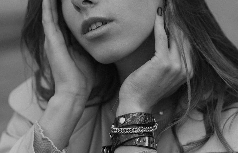 A person in a dynamic yoga flow pose in a spacious studio.