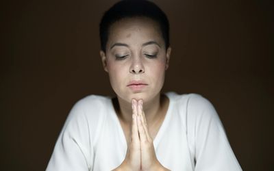 A person's calm and focused face during meditation.