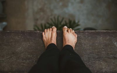 Close-up on hands and feet showing balance and stability.